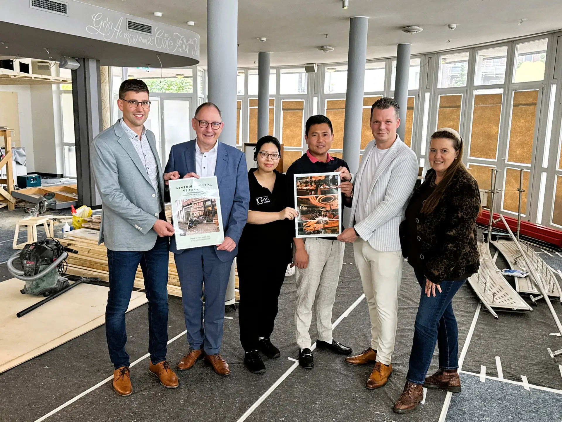 Gruppenfoto der Vorbereitungen für das ChiMi‑Restaurant in Rees mit mehreren Personen, darunter Jörn Franken, Sebastian Hense, Linh Giang Nguyen, Minh Hung Le, Sebastian Zimpel und Sandra Kimm‑Hamacher.